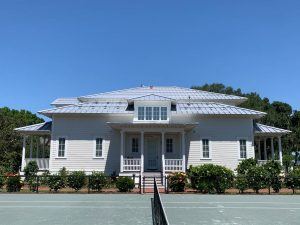 Street view of solar racks installed on a metal roof in WInter Haven, FL